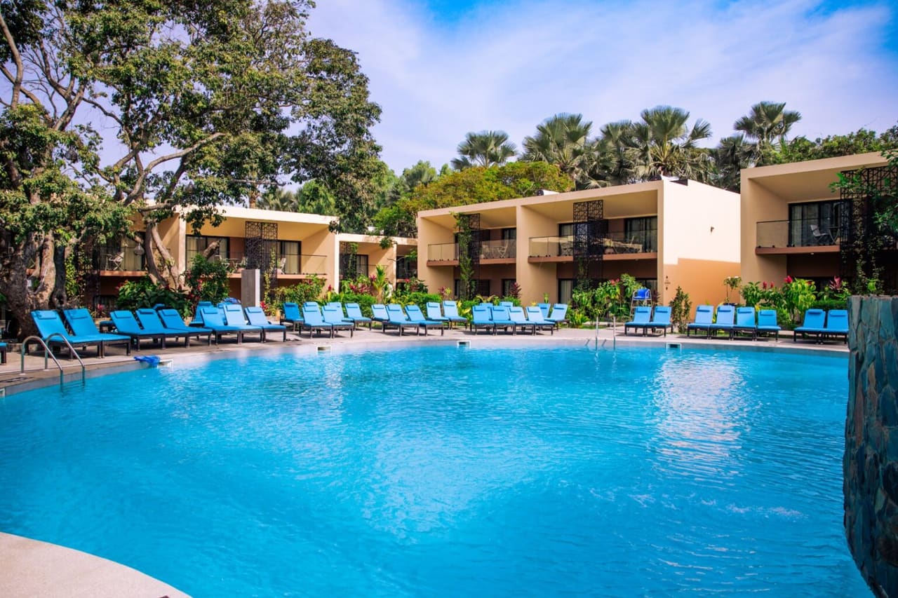 Pool courtyard at Bakadaji Hotel with sun loungers and two-storey guest blocks behind